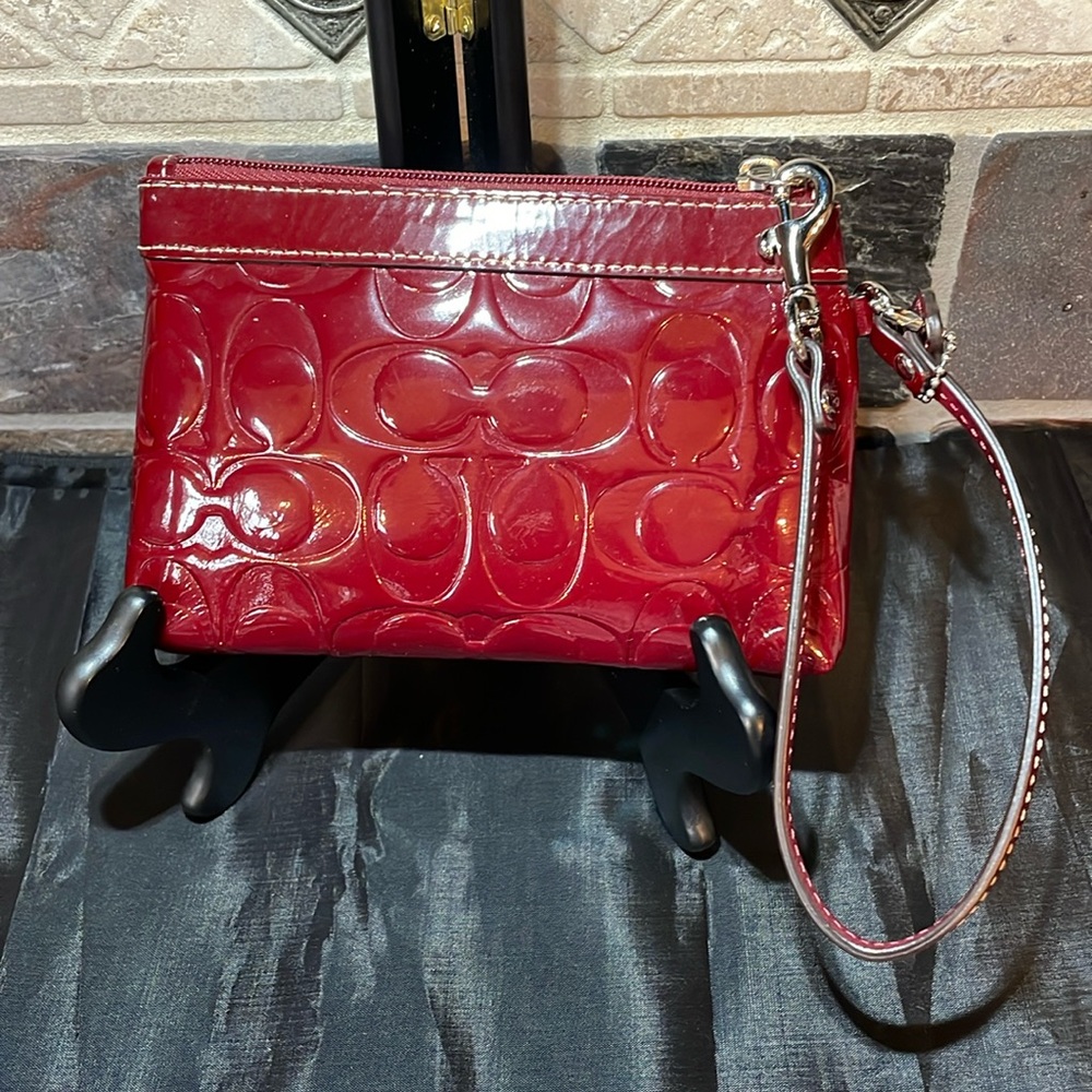 NWOT Coach wristlet in burgundy patent leather with monogram C’s